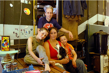 Dinah and Stig Mason with sons Yosse, 8, and Dahli, 9, and Moo the dog at their lorry home    MARCUS THOMPSON EXMT20110614F-003_C